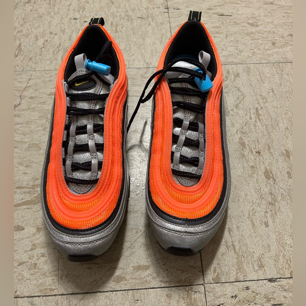Orange and silver Nike shoes